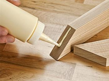 Applying glue on wood planks
