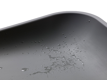 Close up of grey waterproof changing mat with water drops on it